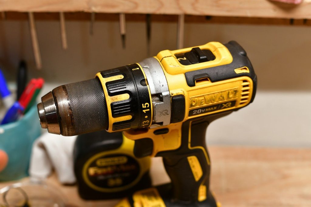 Best Cordless Drill Combo Kits for New Woodworkers: Top 5 Reliable Sets Yellow and black cordless power drill on a workbench.